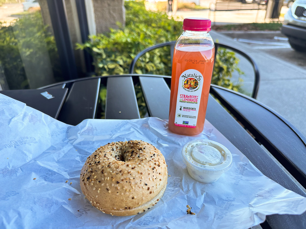 table with everything bagel and cream cheese with lemonade